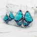 Handmade turquoise butterfly wing earrings in clear resin