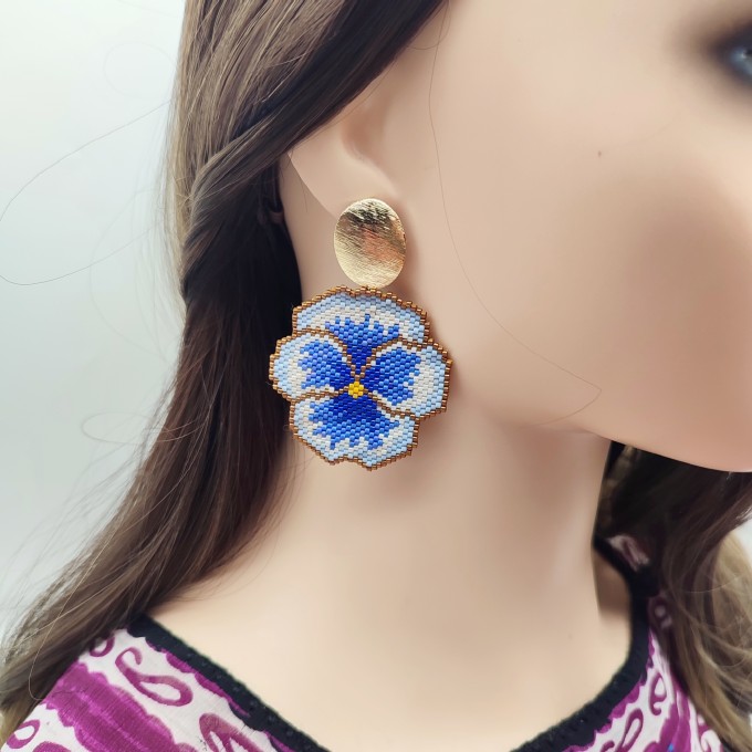 Handmade pansy flower earrings with blue, gold, and white accents