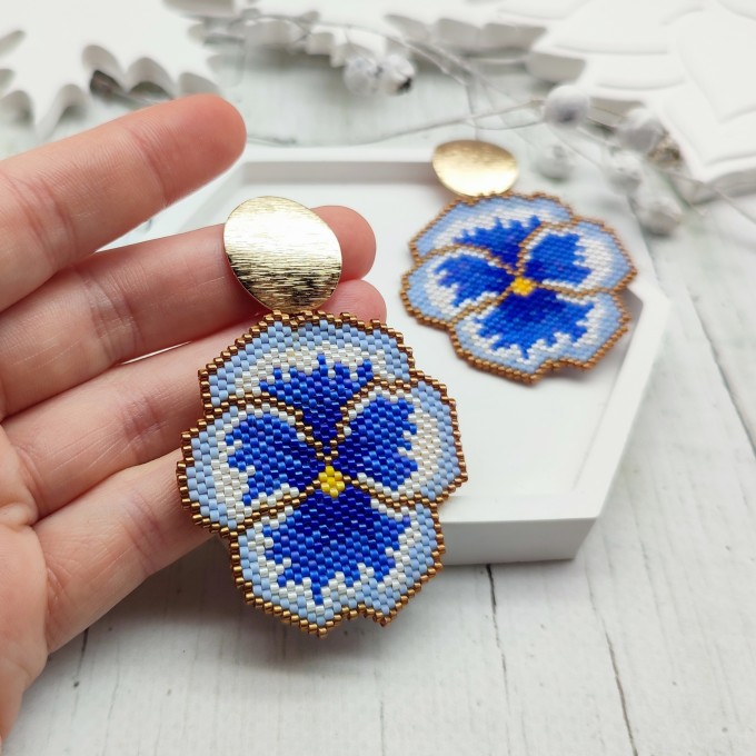 Handmade pansy flower earrings with blue, gold, and white accents